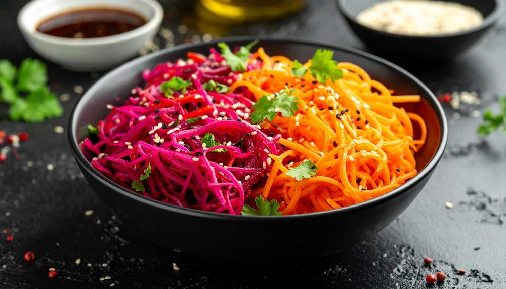 Asian Red Cabbage and Carrot Salad with Cilantro and Sesame, serve in a black bowl