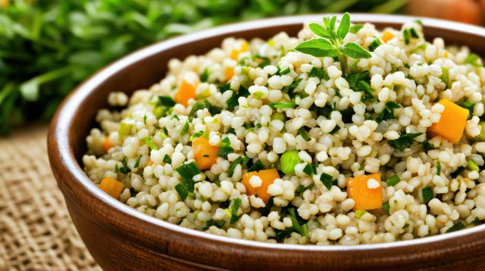 Barley salad with carrots peas and parsley serve in a bowl