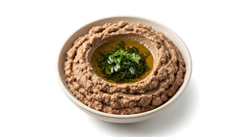 Fava Bean Dip with oil and parsley serve in white bowl