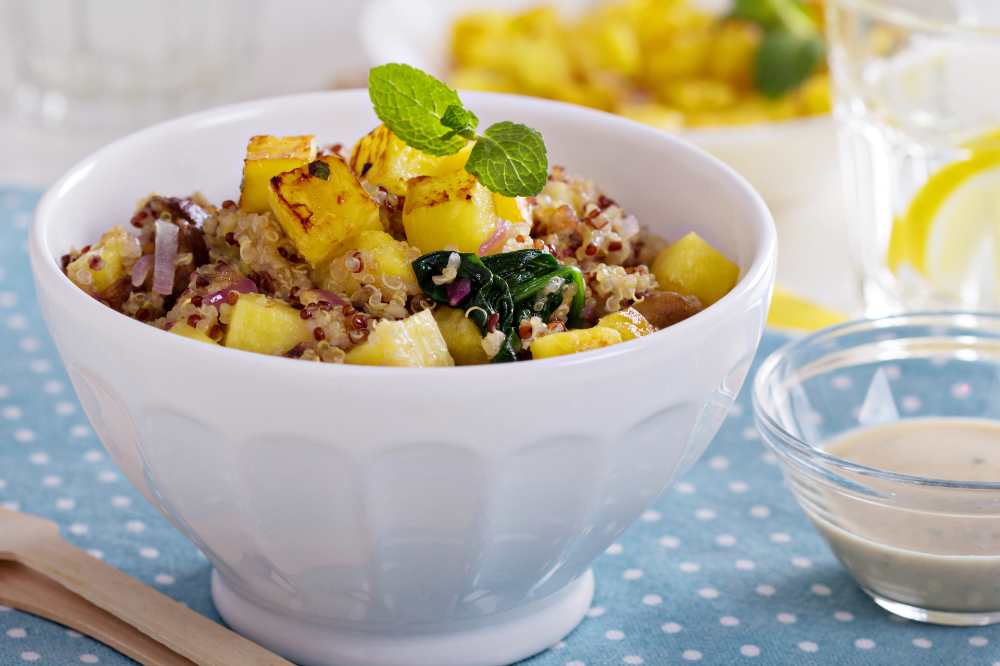 Quinoa with Grilled Pineapple, Red Onion and Spinach serve in a white ball