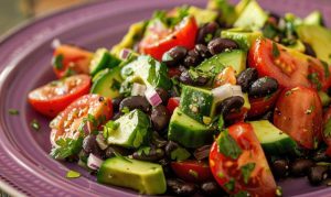 Avocado and black beans salad with cherry tomato, red onion garnish with parsley, serve on a plate