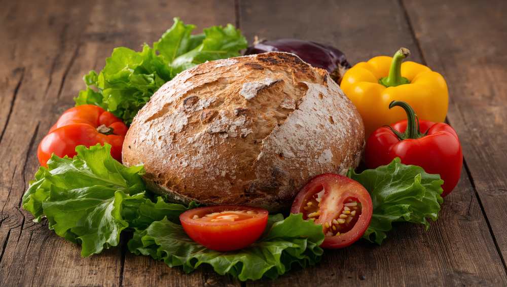 Bread and vegetable, tomato, bell pepper on a rustic wooden table