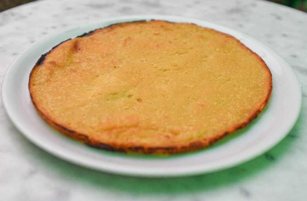 Faina, dish made from chickpea flour, which is similar to a savory, thick pancake or flatbread, serve in a white plate