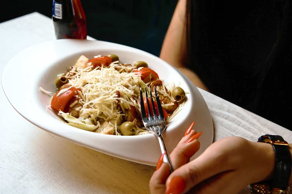 A fork over a plate of food, top view