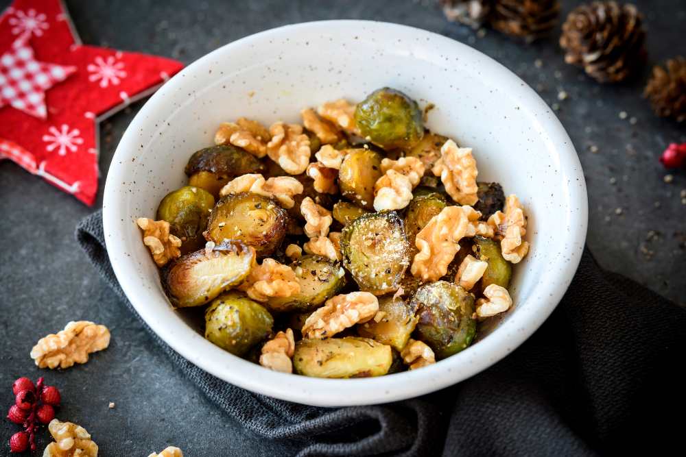 roasted brussel sprouts and walnuts salad, serve in a white bowl
