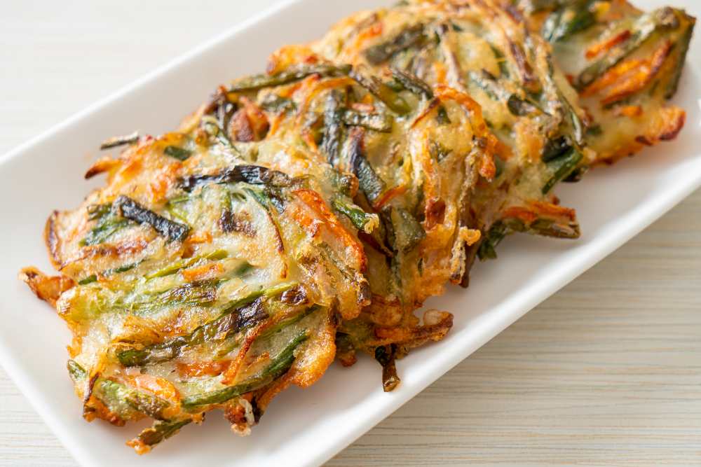 pajeon korean-pancake serve on a long white plate , close-up top view.