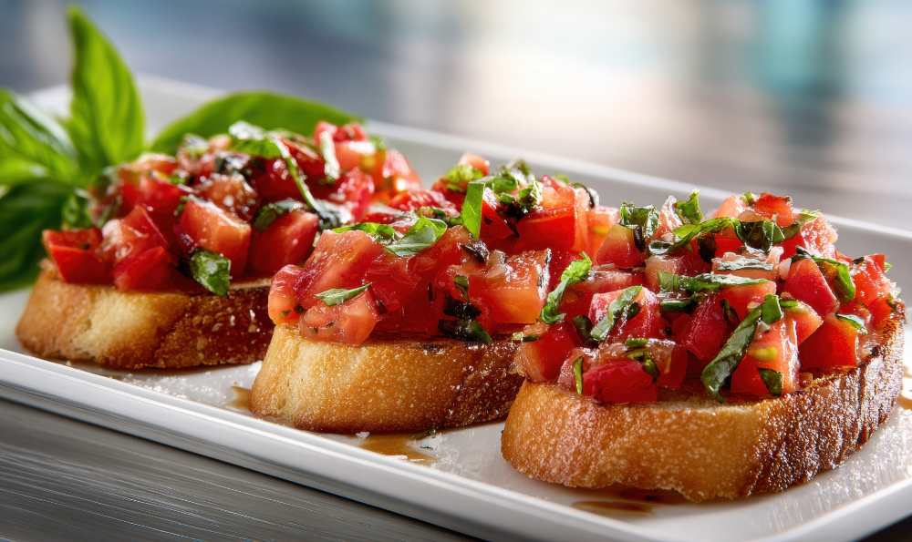 Bruschetta with Tomato and Basil, serve in a long white plate , close-up side view.