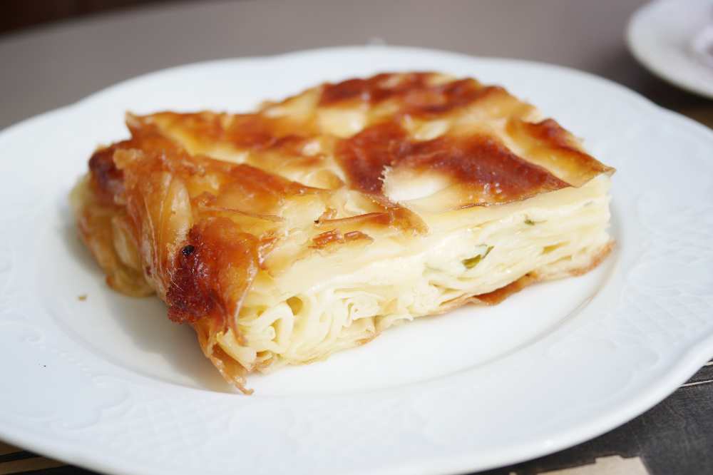 Traditional Turkish borek, serve on a white plate , close-up top view