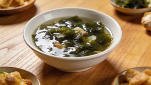 seaweed soup, serve in a white bowl on a wooden table, top-view