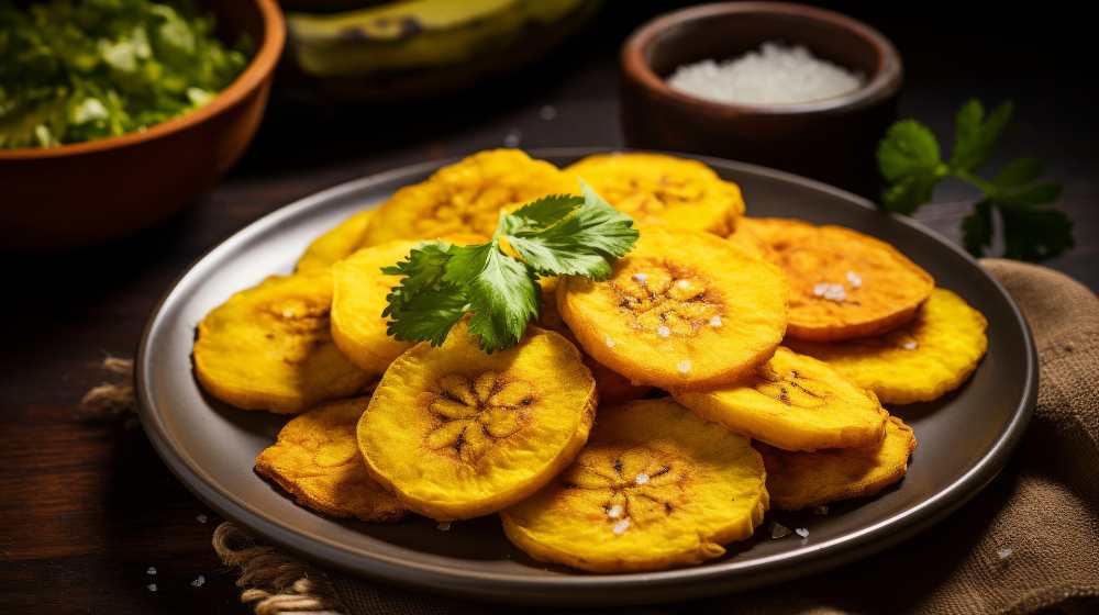 Cuban tostones, serve in a plate top with cilantro, close up top view.