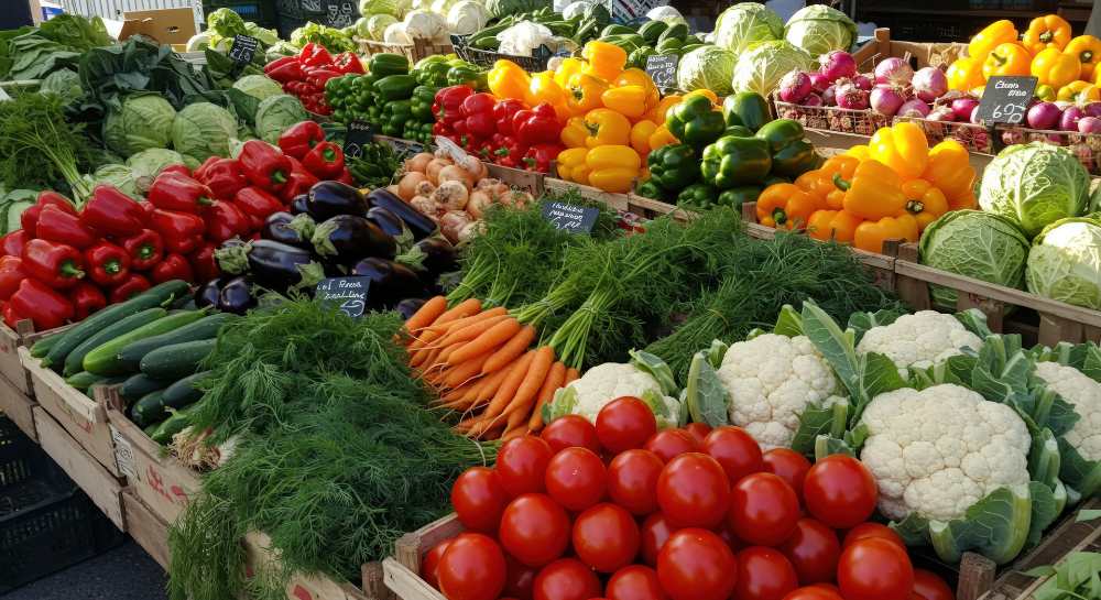 variety of fresh vegetables at farmers market produce stand