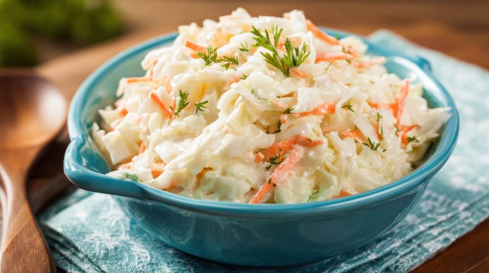 Creamy coleslaw serve in a blue bowl close up , side view.